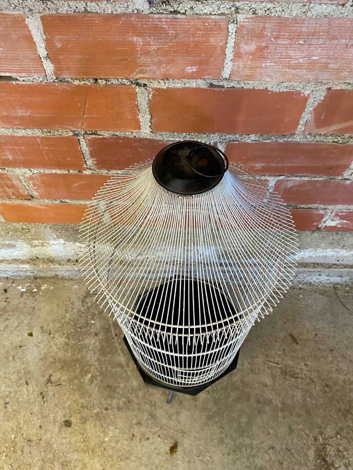 Antique black & white metal bird cage on vintage decorative legs