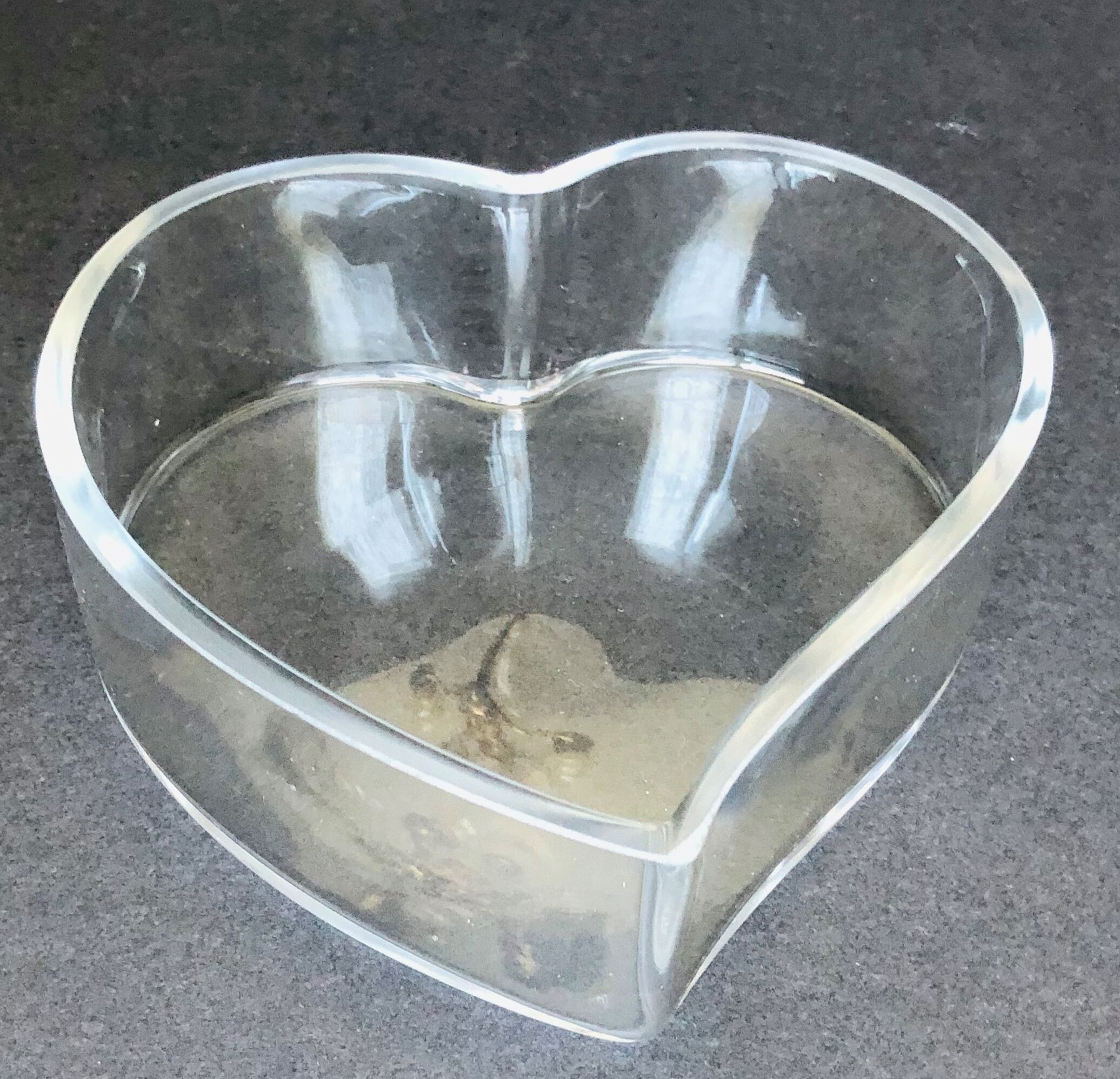 Empty glass heart-shaped pocket