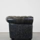 Spacious black cow leather chesterfield armchair with distinctive character