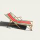 Vintage deck chair with striped green and red fabric, original patina.