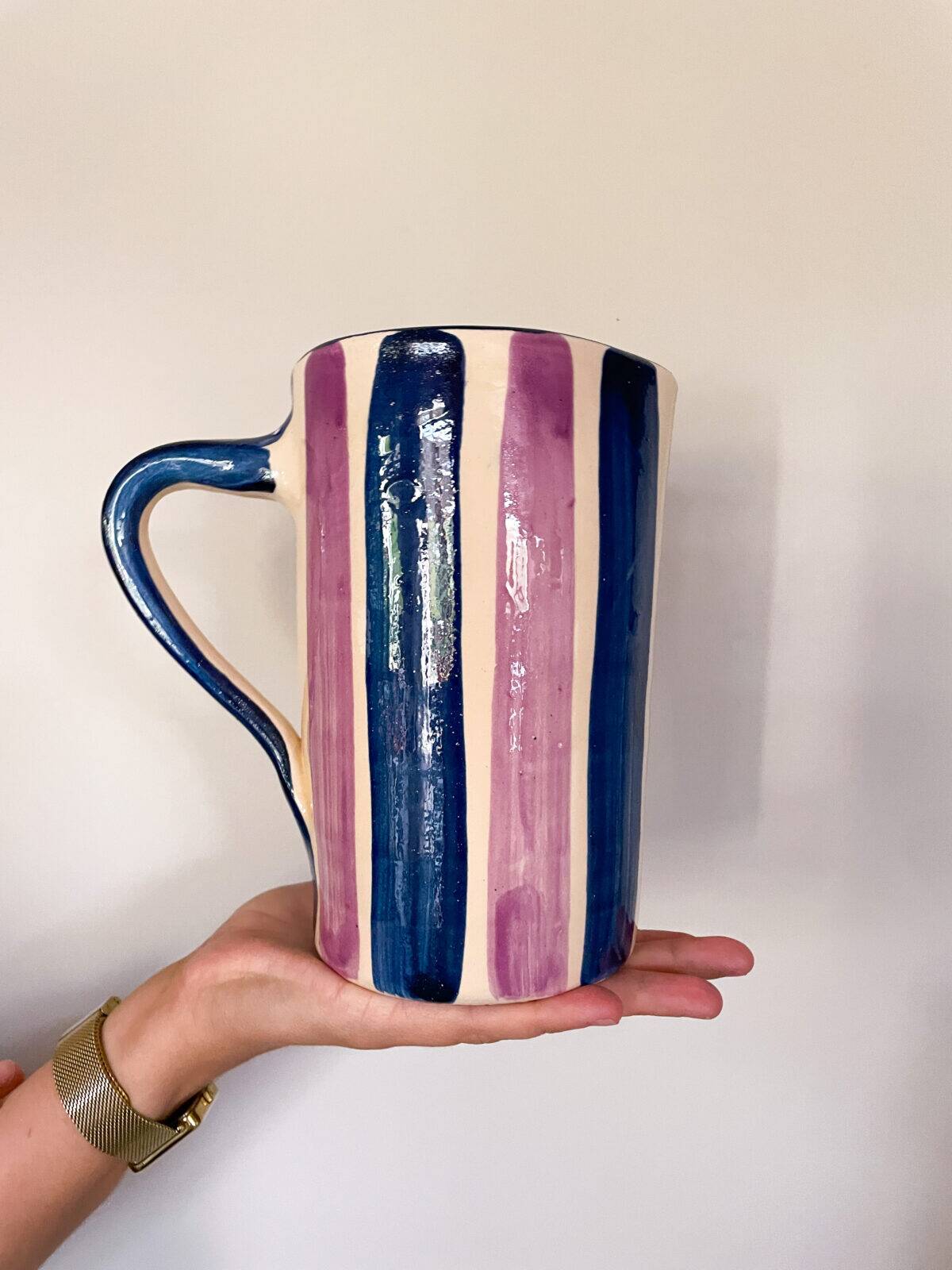 Blue and purple striped ceramic pitcher