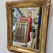 Antique gilded mirror, 19th century Empire style.