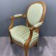 Pair of Louis XVI style armchairs in striped green fabric, 20th century.