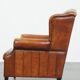 Sheepskin wingback armchair with stitching and black piping