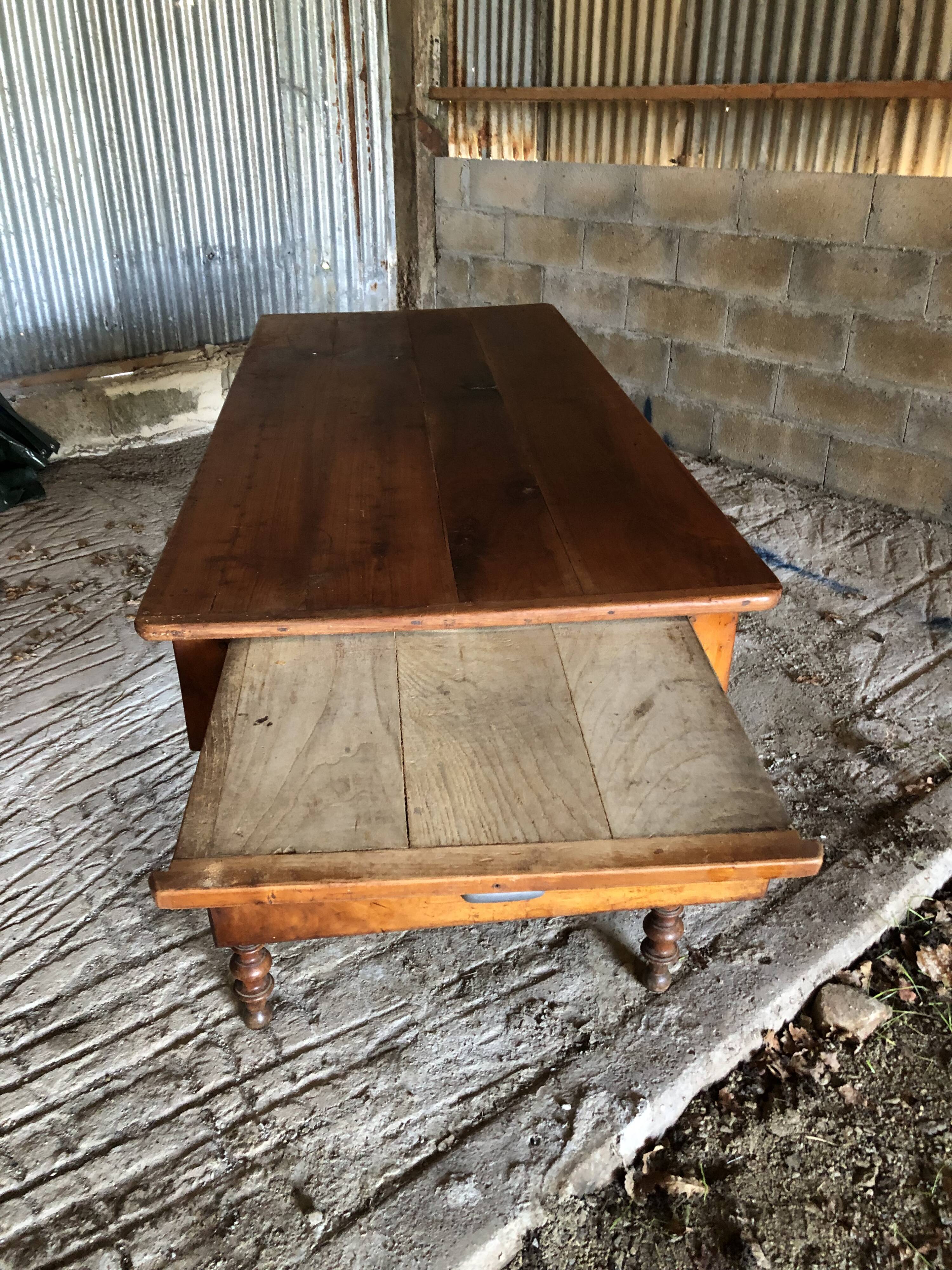 Antique Louis Philippe style farm table in solid cherry wood with turned base.