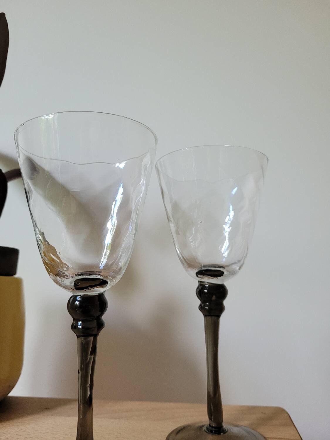 Two smoked black stem wine glasses