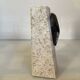 An asymmetrical travertine and fossil bookend.