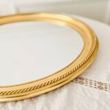Oval wall mirror in gilded wood