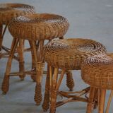 A set of 4 vintage Scandinavian rattan stools, in the style of Tony Paul, from the 1960s.