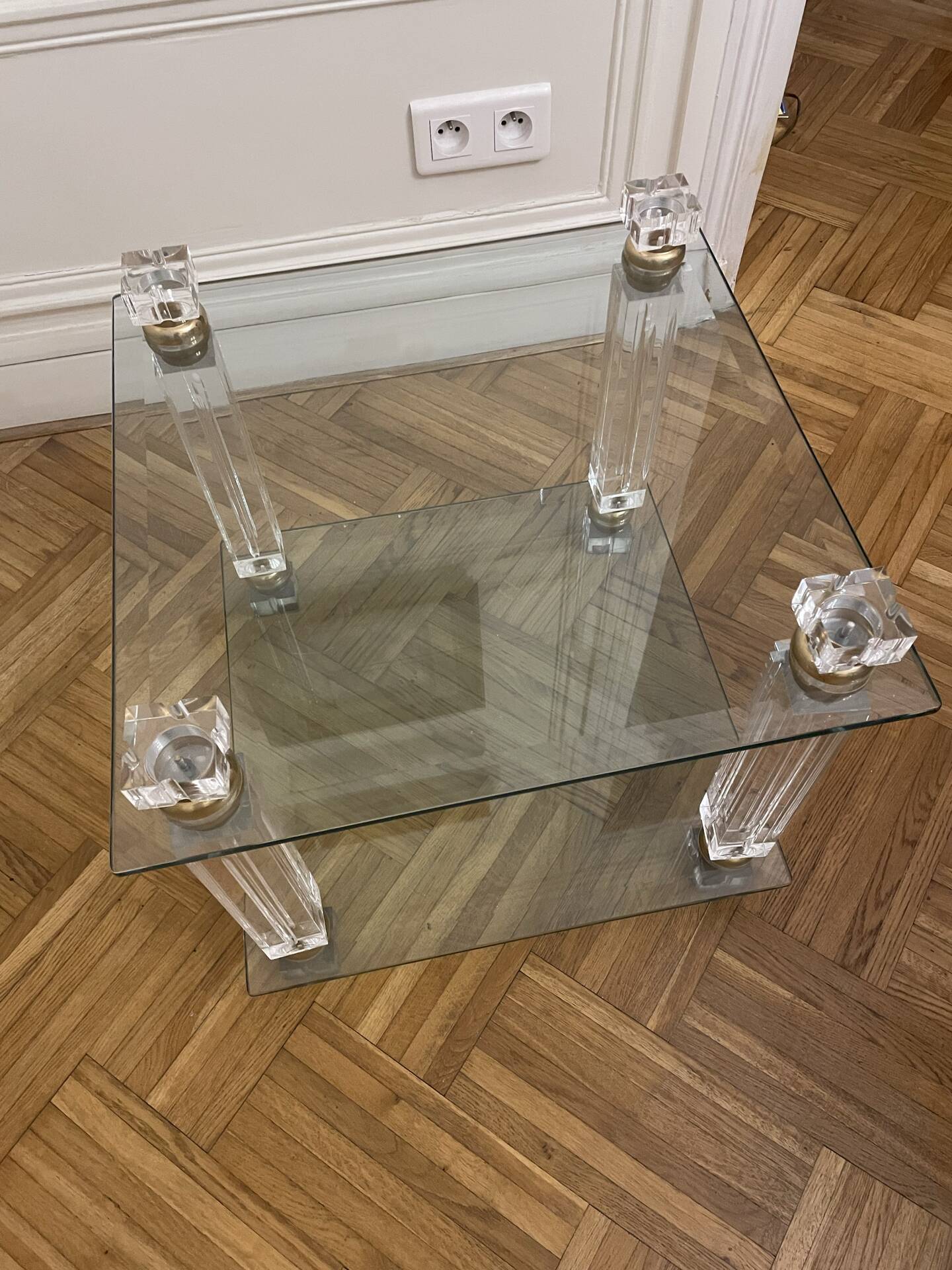 Glass side table with gold decorations.