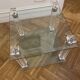Glass side table with gold decorations.