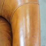 Sheep leather club chair in a cognac color with patina