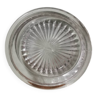 Vintage pressed molded glass plate under bottle