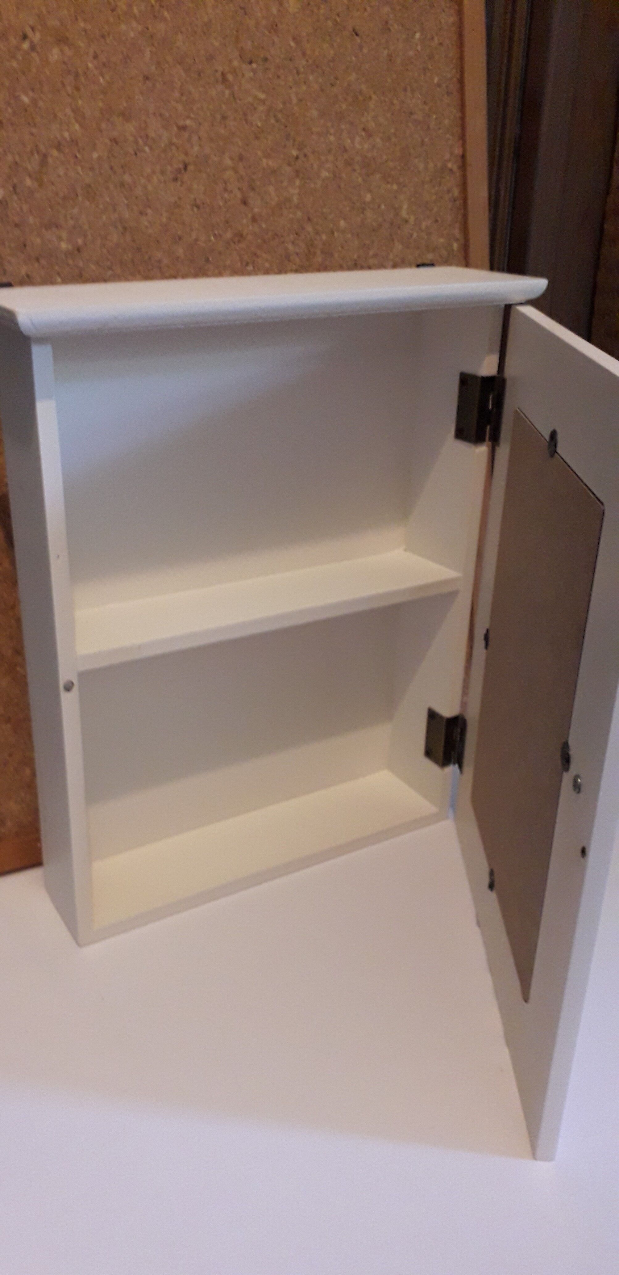 White mirrored toilet cabinet with floral pattern