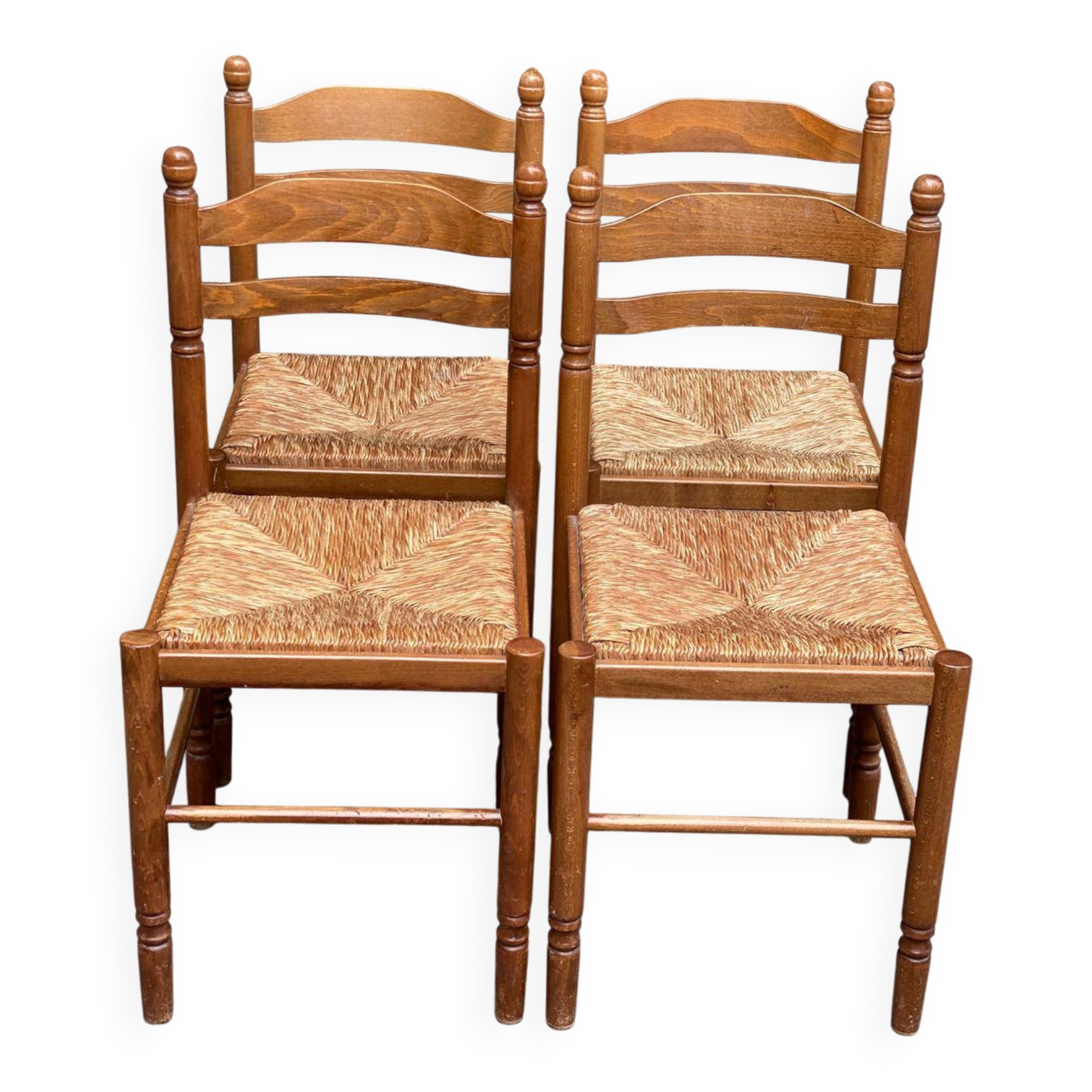 4 solid wood kitchen chairs with straw seats in a country farmhouse style.