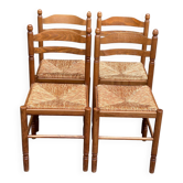 4 solid wood kitchen chairs with straw seats in a country farmhouse style.