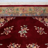China wool fringed rug with floral pattern on deep plum background 393x274cm