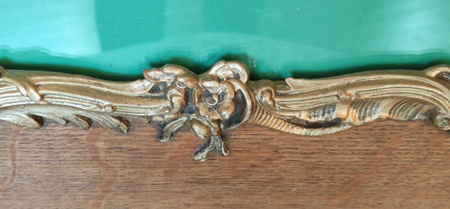 Old wooden frame and bronze ornament