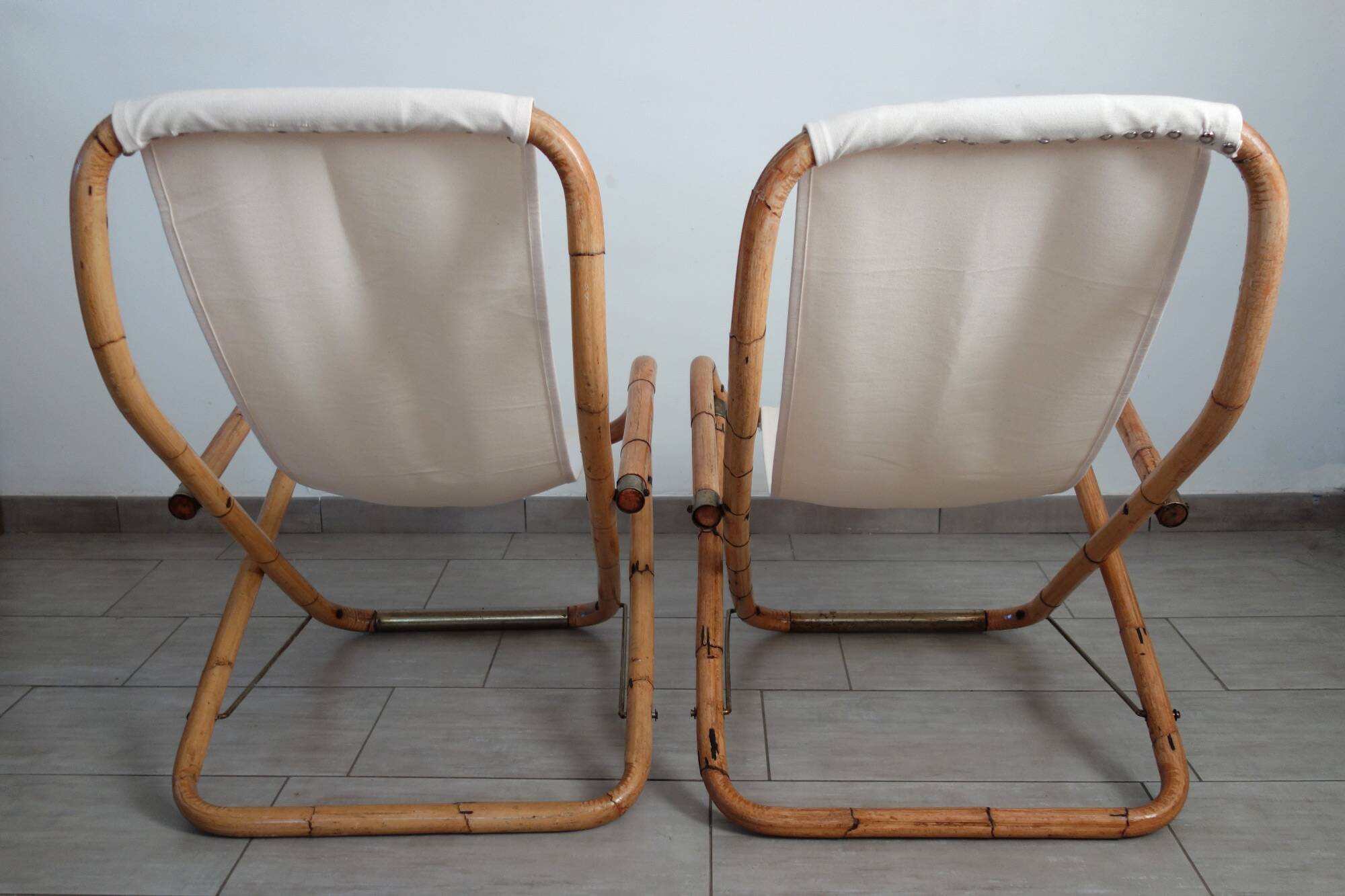 Pair of folding bamboo and brass deck chairs, Italy, 1960s.