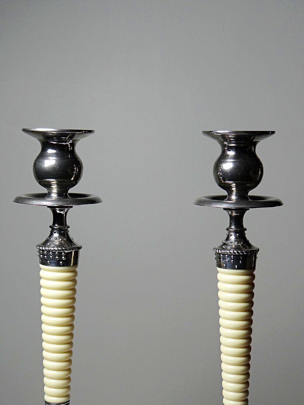 Pair of vintage candlestick holders in silver-plated metal with ivory-style plastic.