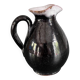 Antique black pitcher with white collar