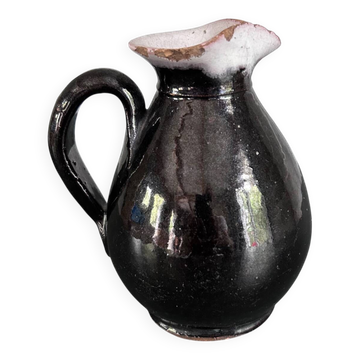 Antique black pitcher with white collar