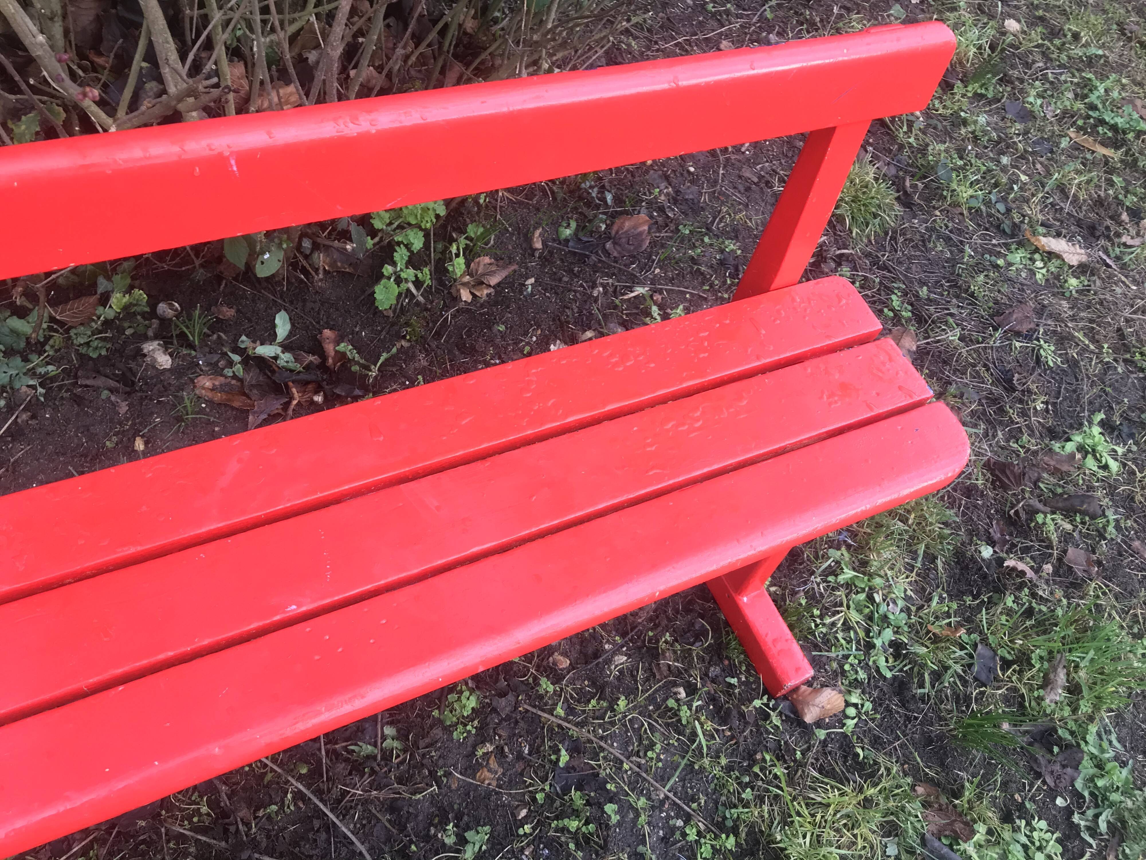 Red old schoolboy bench