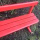 Red old schoolboy bench
