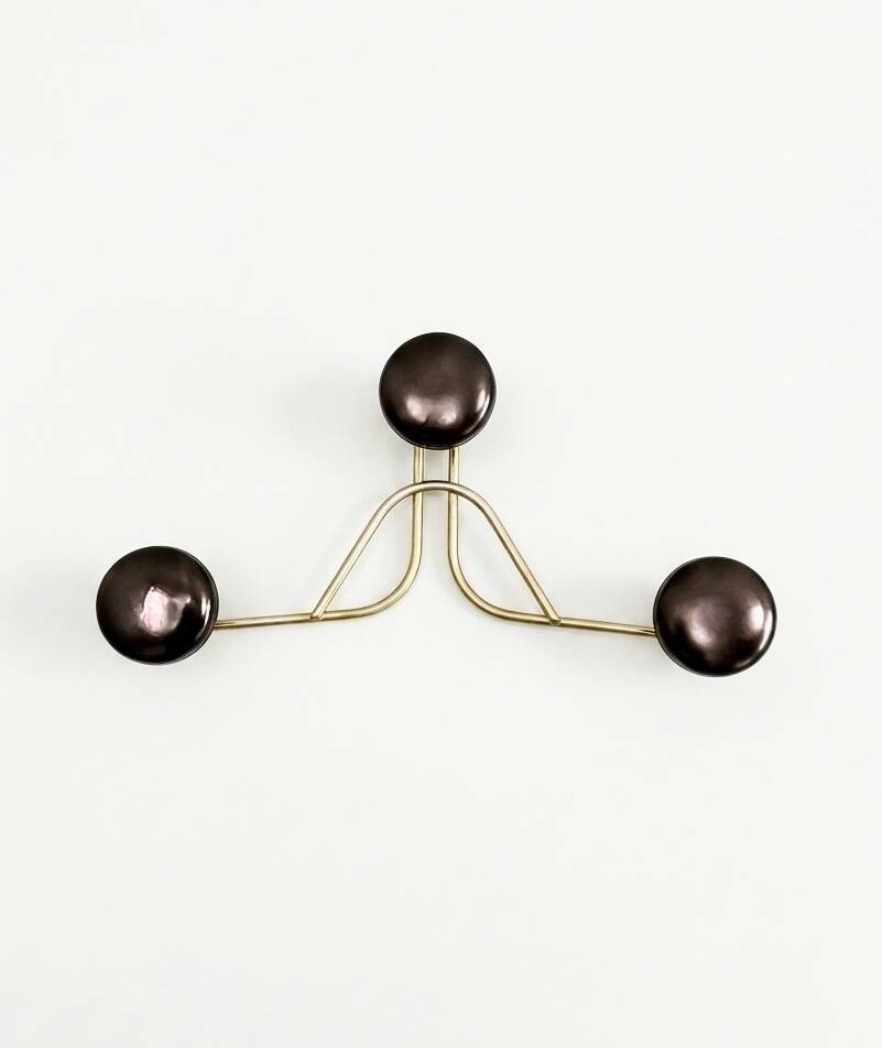 Golden brass coat rack with 3 black vintage hooks from the Mid Century 1950-60.