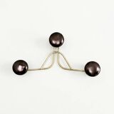 Golden brass coat rack with 3 black vintage hooks from the Mid Century 1950-60.