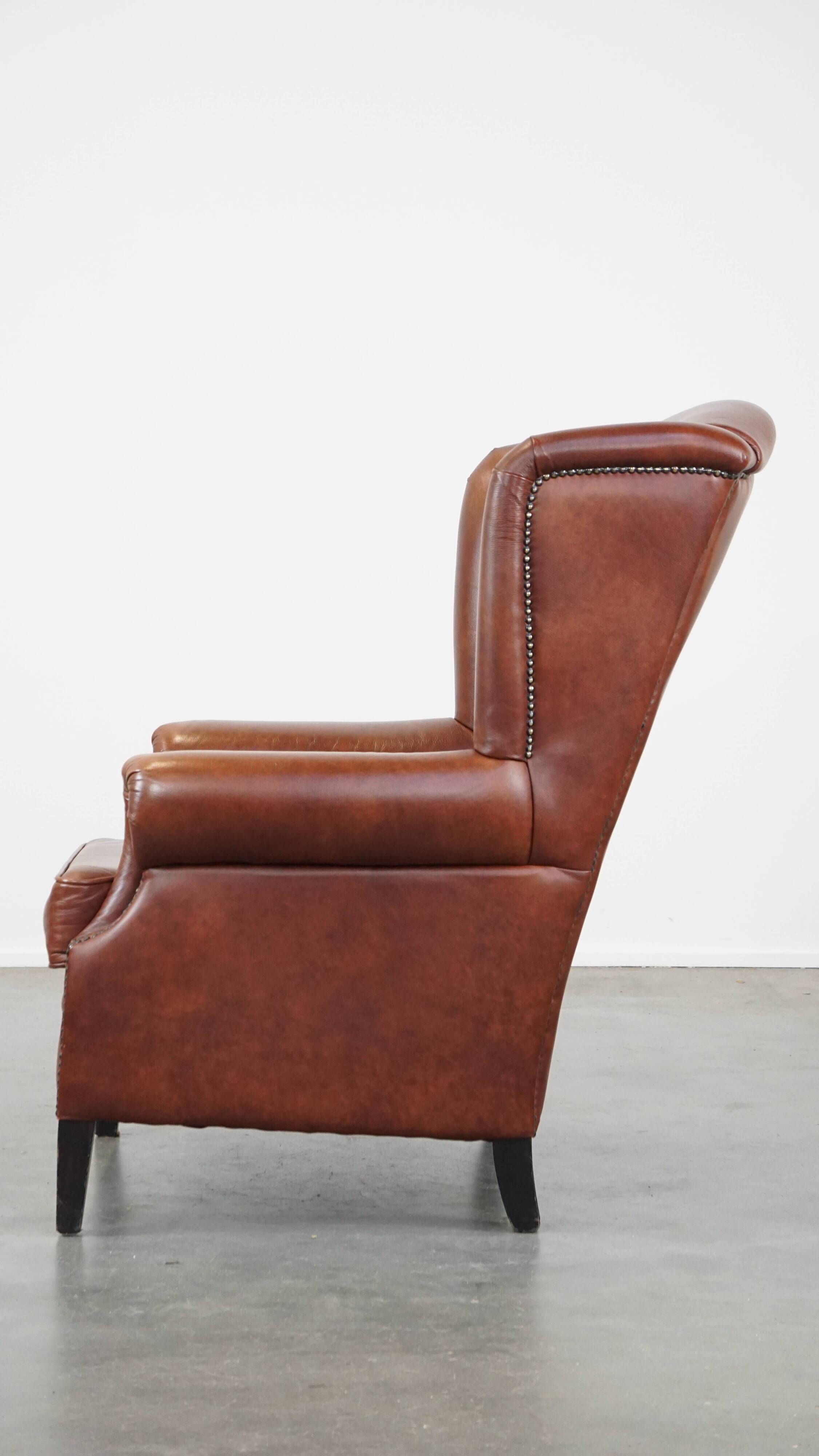 Cognac-colored cowhide wingback chair