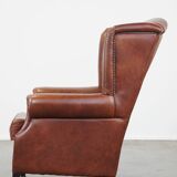 Cognac-colored cowhide wingback chair