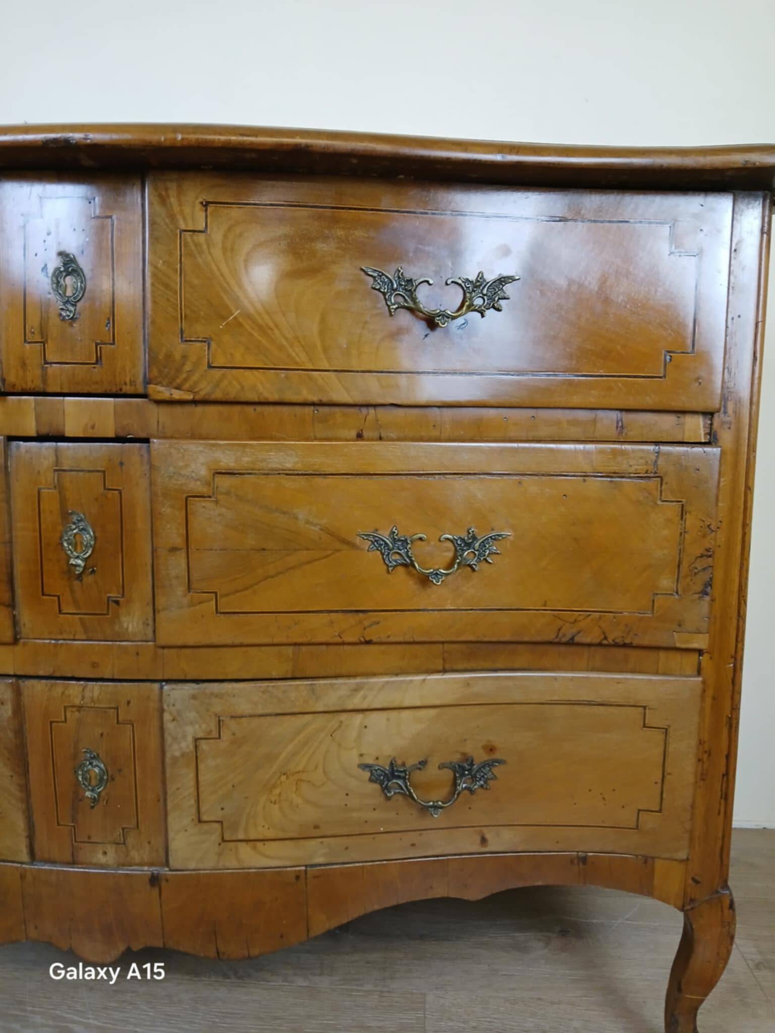 Louis XV period curved chest of drawers in elm and marquetry fillets circa 1750