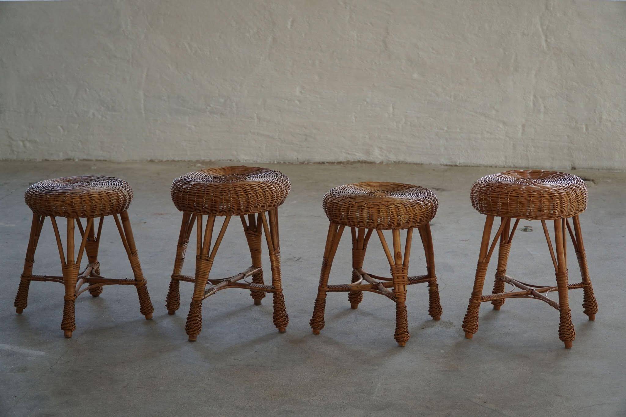 A set of 4 vintage Scandinavian rattan stools, in the style of Tony Paul, from the 1960s.