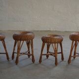 A set of 4 vintage Scandinavian rattan stools, in the style of Tony Paul, from the 1960s.