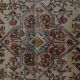 Vintage Turkish rug in beige and red with oriental design, 135 × 210 cm