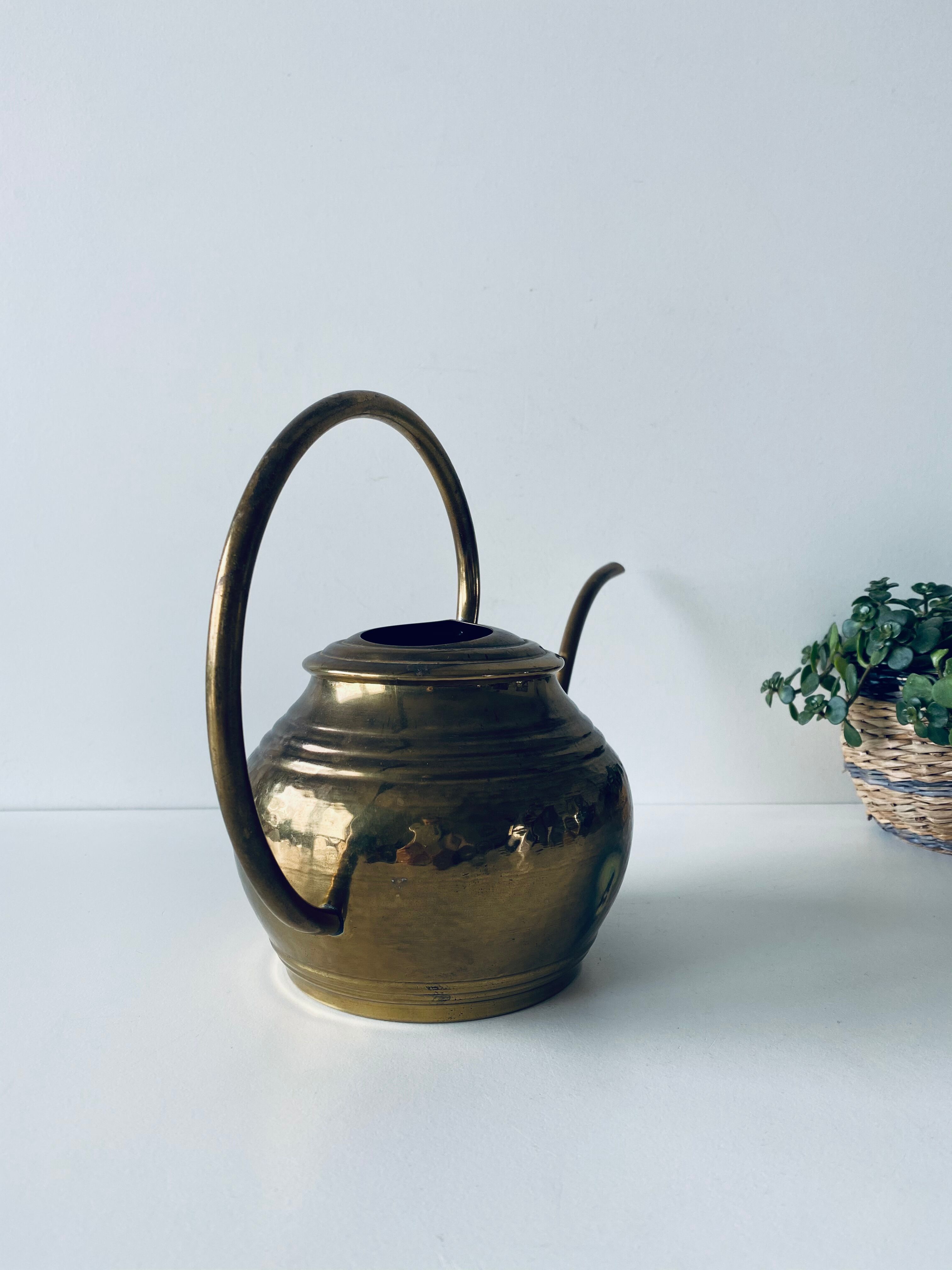 Old brass watering can