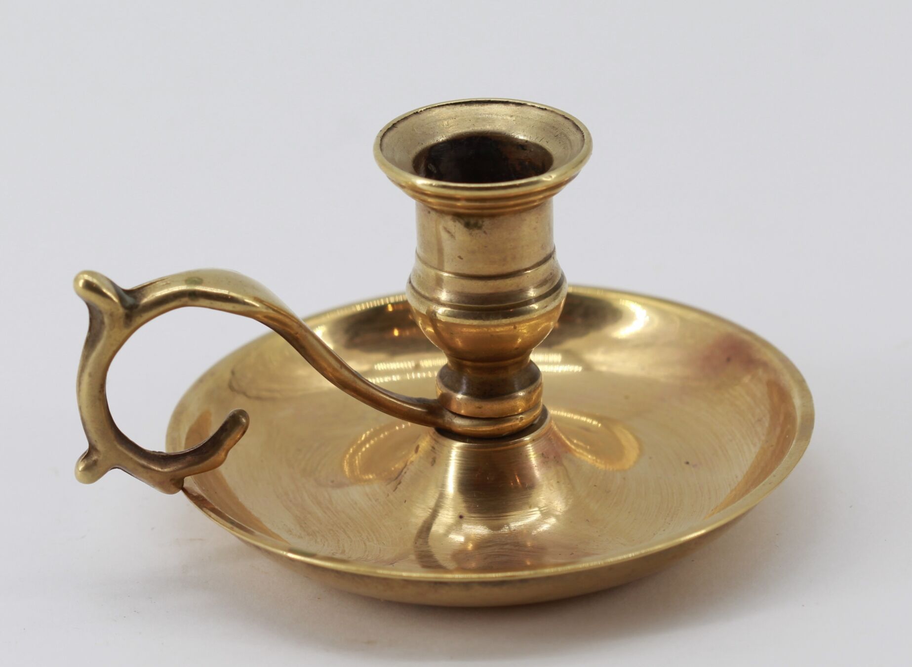 Old brass hand candle holder