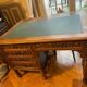 Solid wood desk and green leather writing pad