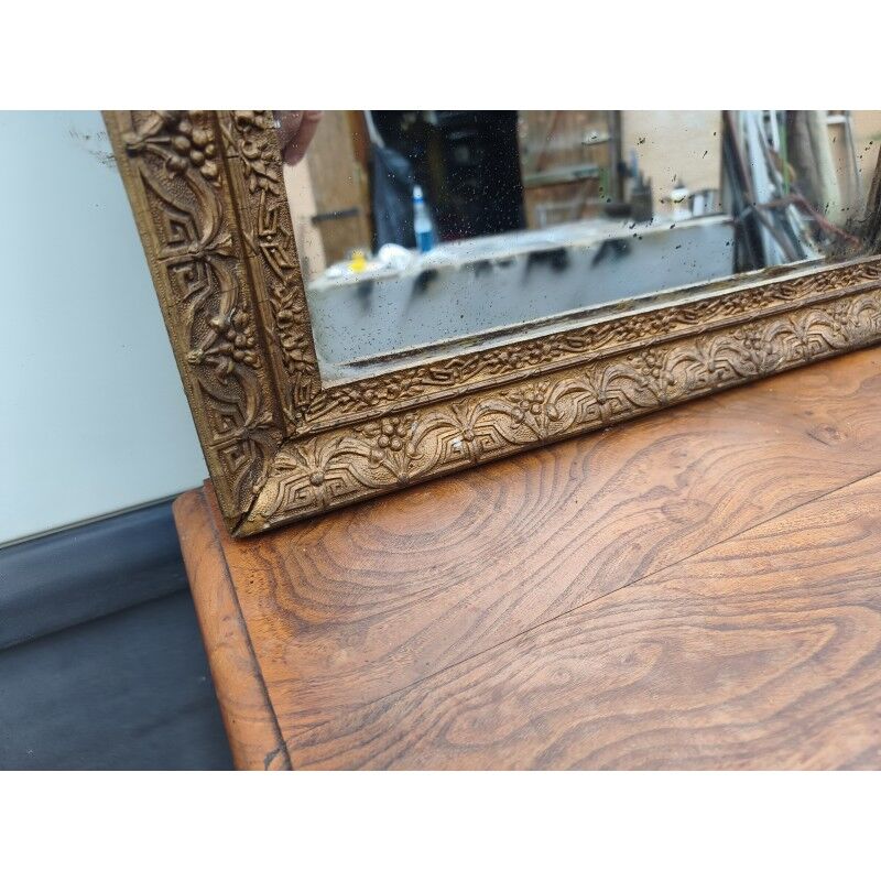 19th-century fireplace mirror in gilded wood and stucco.