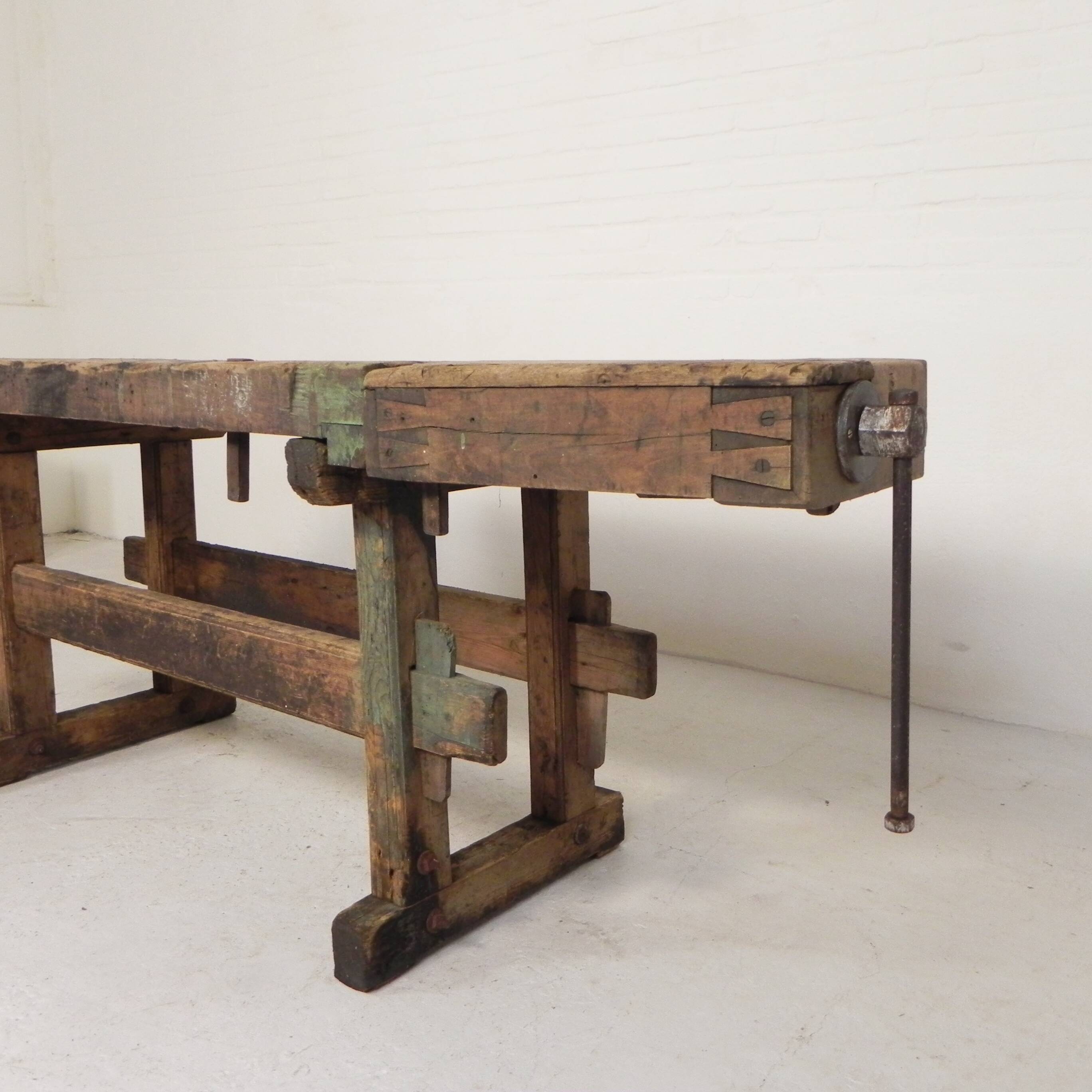 Wooden industrial workbench with vice, 194 cm long, 1930s.