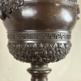 Patinated bronze vase with handles topped by bicéphalic busts, 19th century.