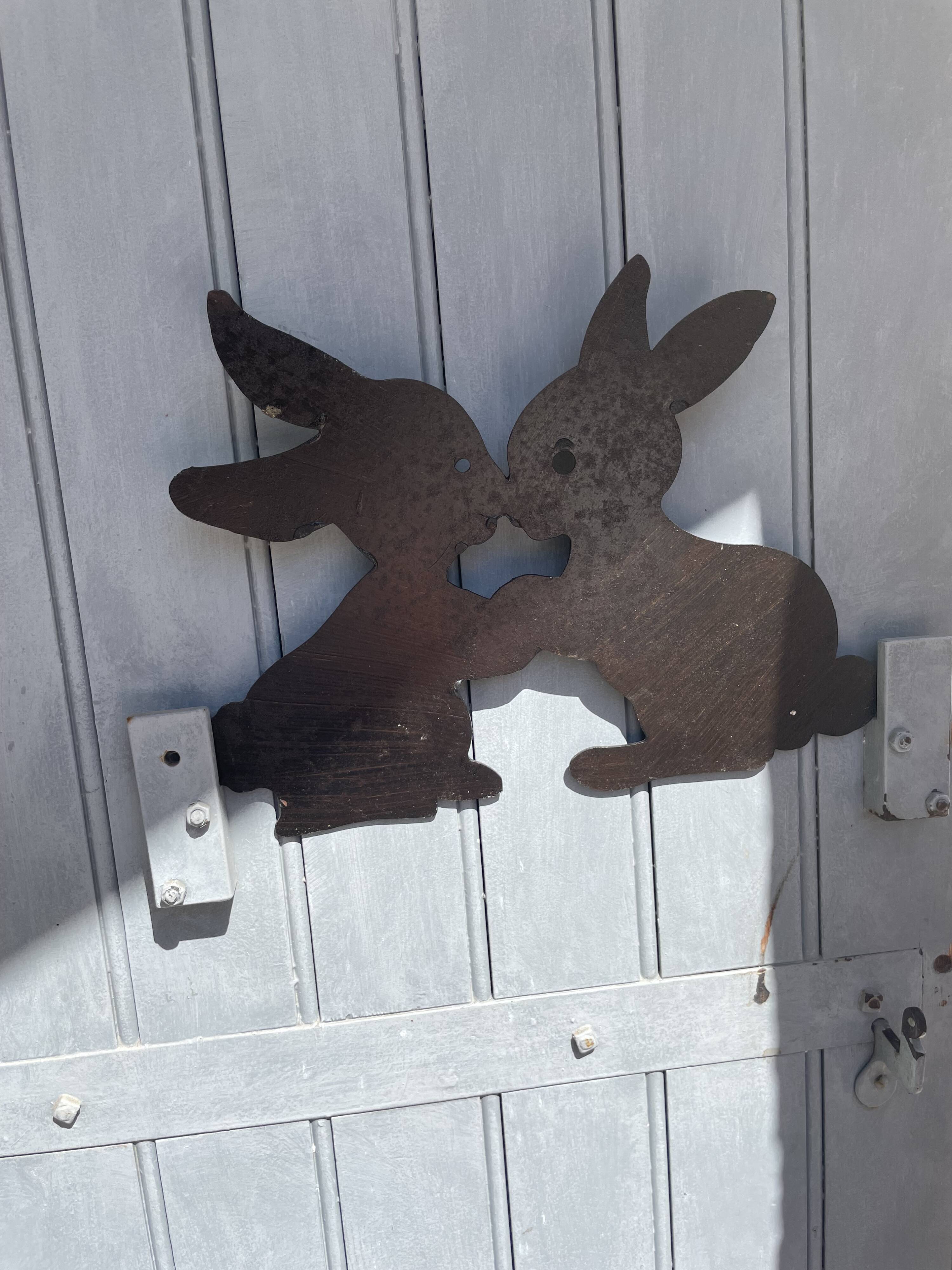 Cast iron plate in the shape of rabbits
