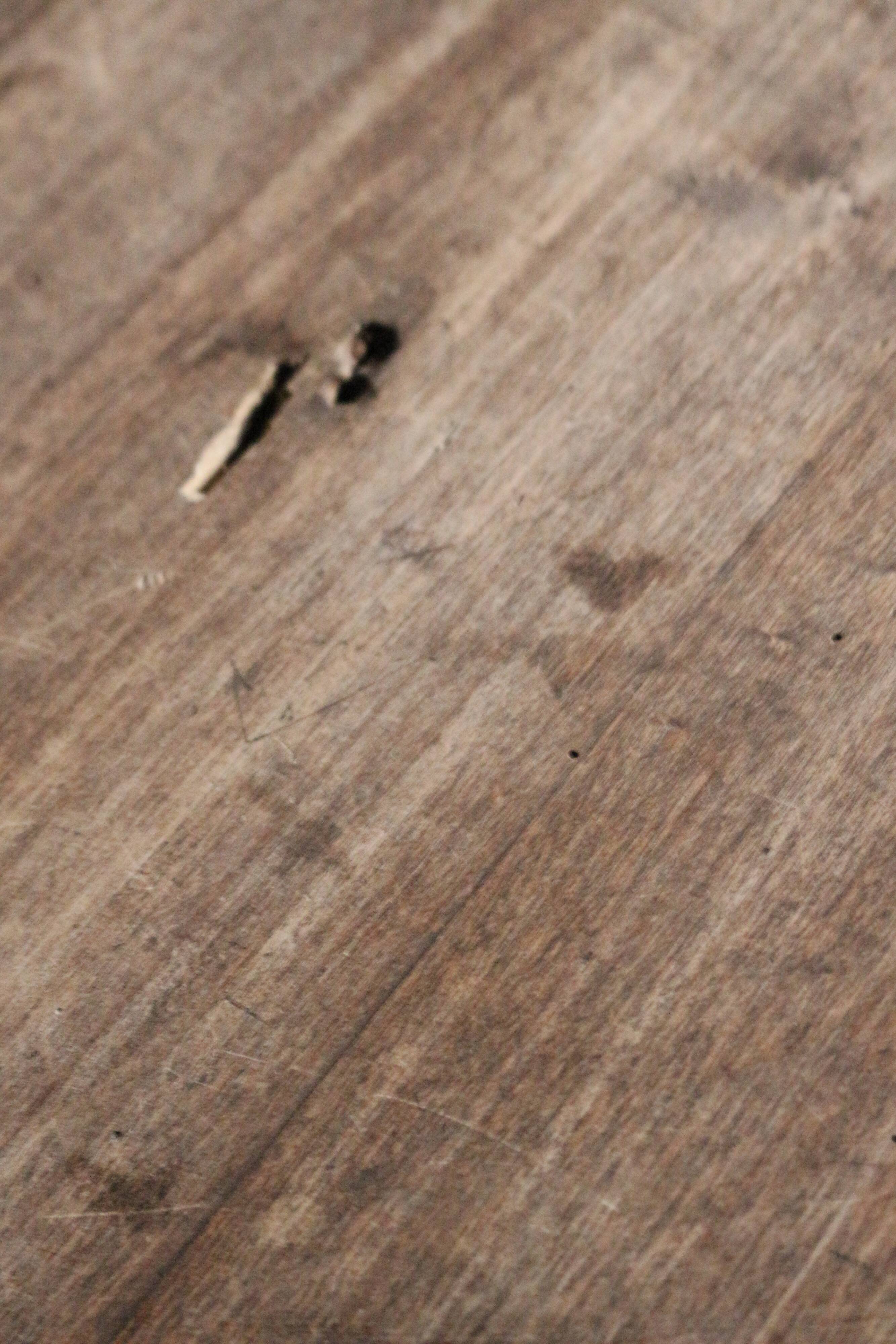 Old oval pedestal table in raw wood