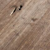 Old oval pedestal table in raw wood