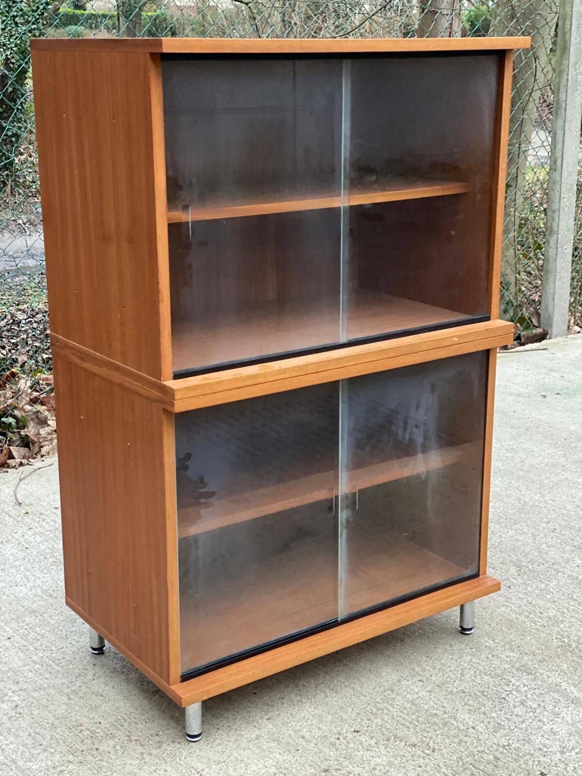 Scandinavian wooden buffet cabinet with sliding glass doors.