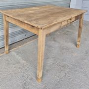 Old farmhouse table with its 2 extensions and raised legs.