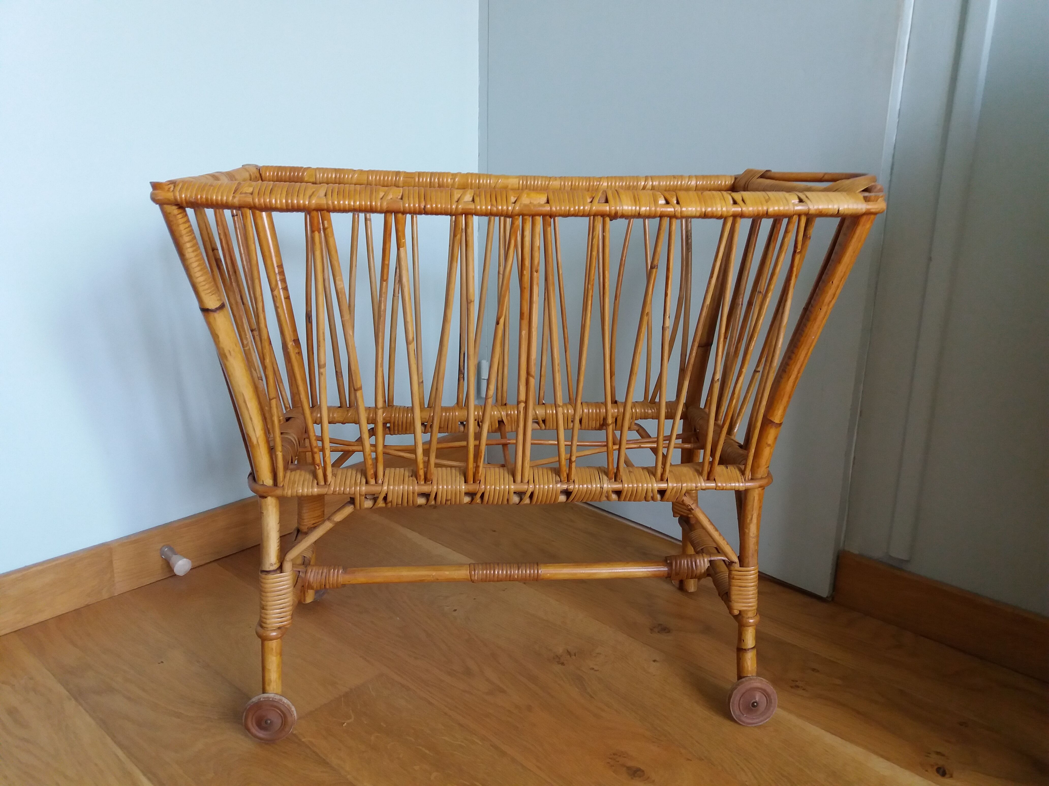 Rattan wicker cradle on wooden wheels