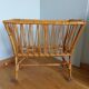 Rattan wicker cradle on wooden wheels