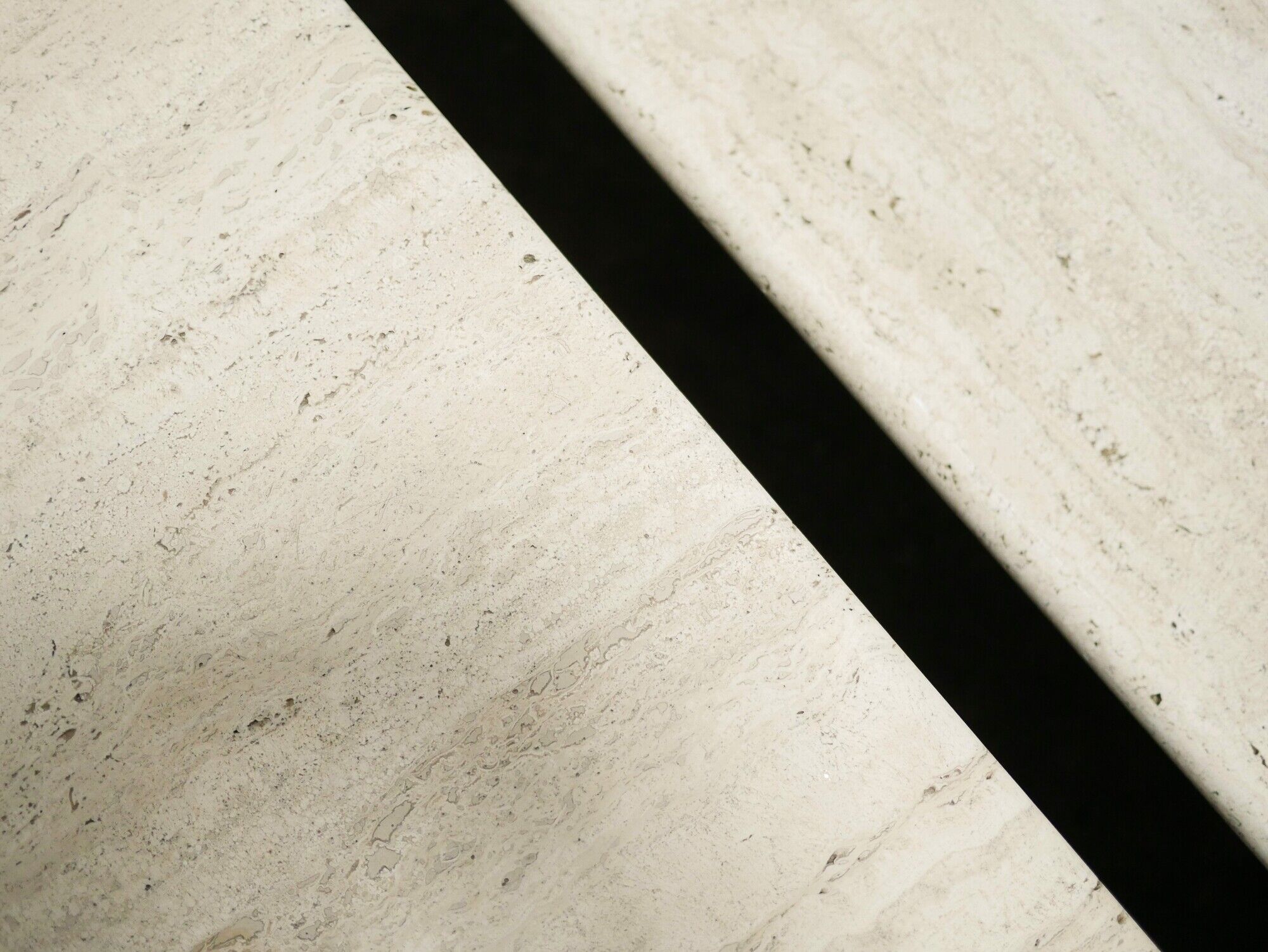Series of 2 vintage travertine coffee tables published by Roche Bobois